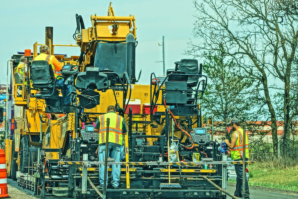 Road construction machinery working along a carriageway.